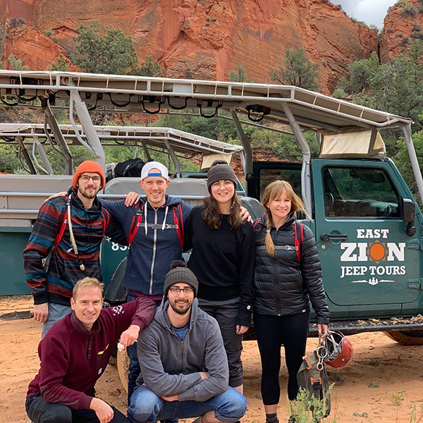 The team stands in front a jeep about to go canyoneering for the first time.