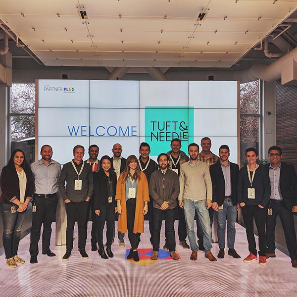 The team stands in the entryway of the Google Partnerplex.
