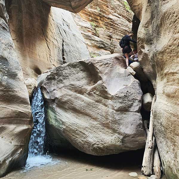 Climbing down a boulder in Zion National Park.