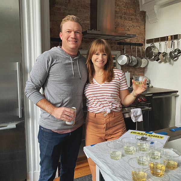 Matt and I stand in the kitchen of our shoot location smiling with our champagne.