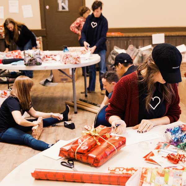 The team and I wrap Christmas gifts for the non-profit Umom.