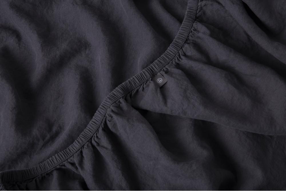 A closeup shot of our linen sheets in charcoal.